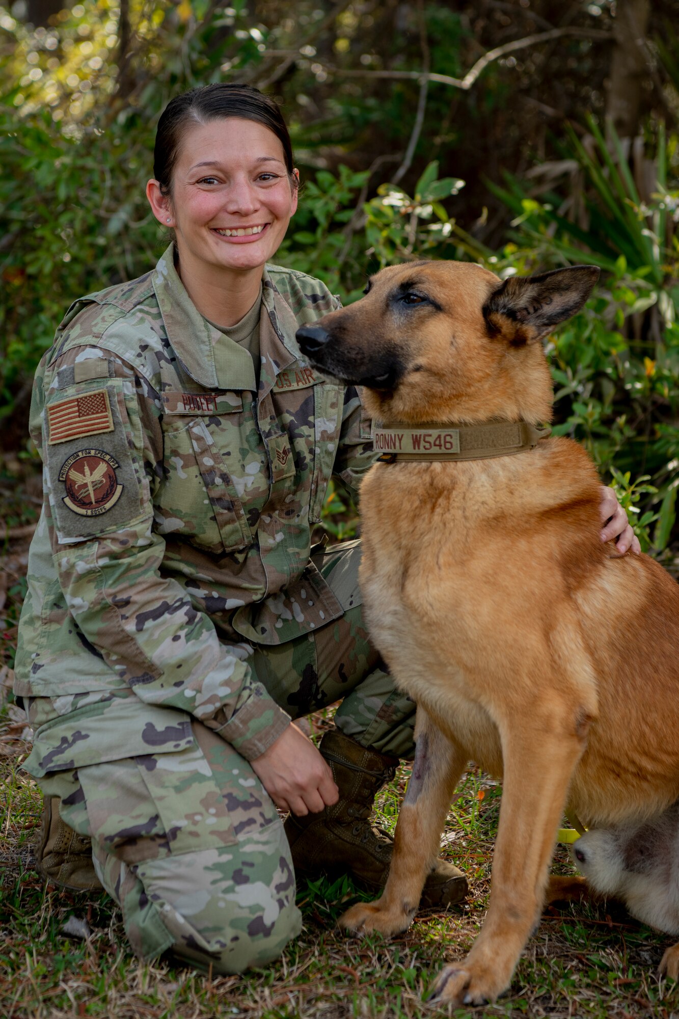 U.S. Air Force Staff Sgt. Jessica Poteet, a military working dog handler with 1st Special Operations Security Forces Squadron, poses with military working dog Ronnie at Hurlburt Field, Florida, March 16, 2021.