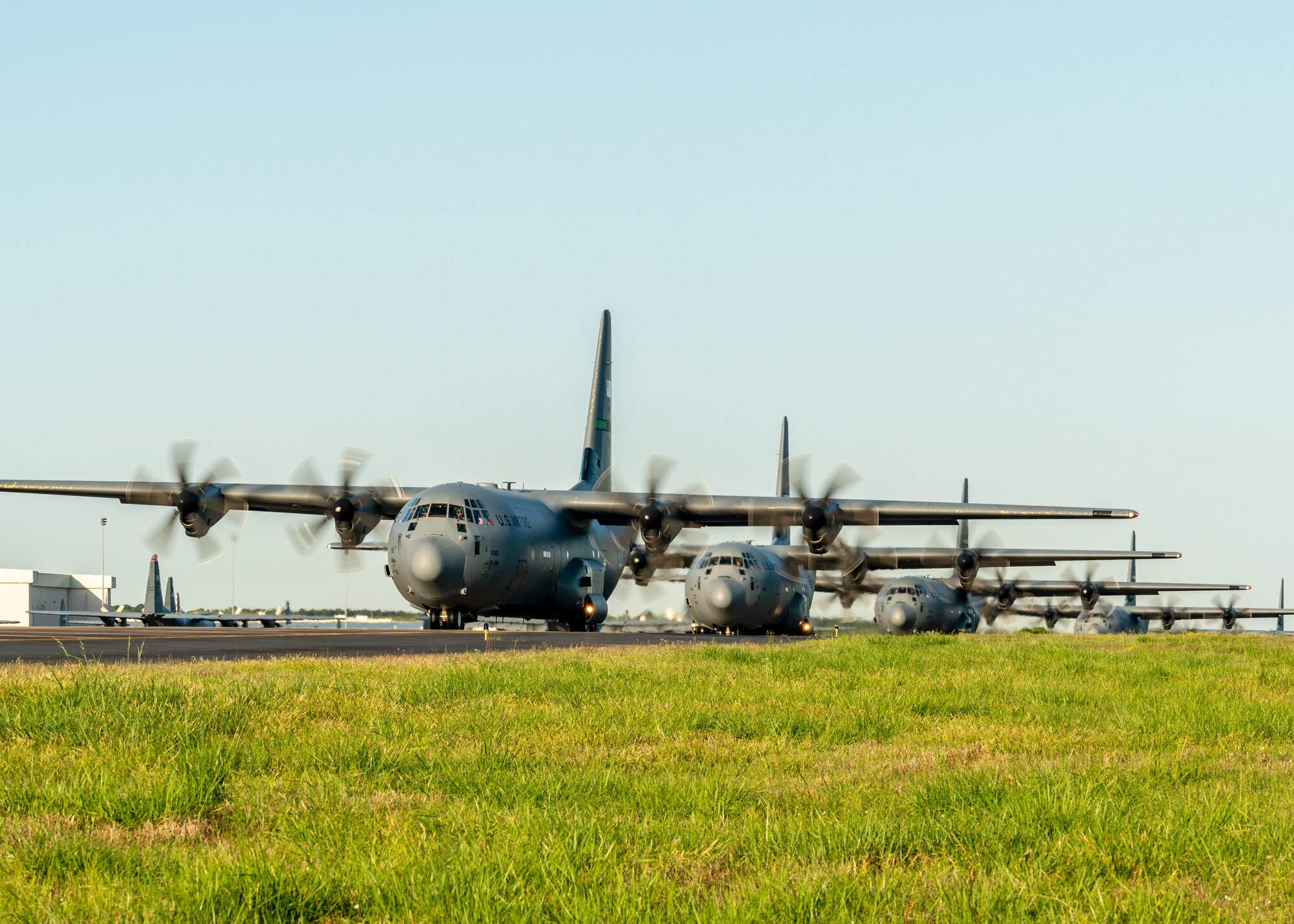 U.S. Air Force C-130J Super Hercules line up on the taxi way as part of an 11-ship formation from Little Rock Air Force Base, Ark., April 15. 2021. The elephant walk quickly launched combat airlift to support an U.S. Army Joint Readiness Training event. (U.S. Air Force photo by Maj. Ashley Walker)