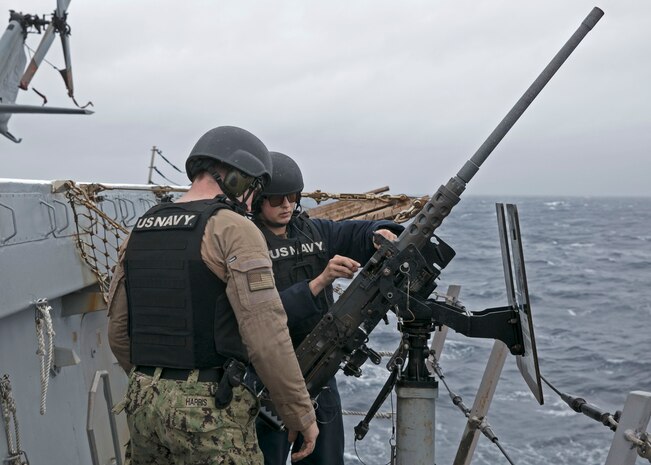 Personnel Specialist 2nd Class Dustin Evans assigned to the amphibious transport dock ship USS San Antonio (LPD 17) reloads the M-2 .50 caliber machine gun on the ship's flight deck, April 1, 2021.