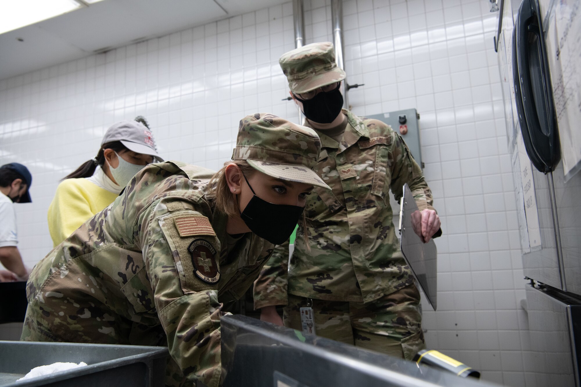 Airmen Check Refrigerator Temperature