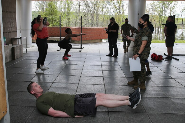 The Marine Corps Recruiting Command G-1 section participates in a Sexual Assault Prevention and Response awareness physical exercise at Marine Corps Base Quantico, Virginia, April 15, 2021. Zuzy Hall, the MCRC Sexual Assault Response Coordinator, and Staff Sgt. Angelica Pulliam, one of MCRC’s SAPR Victim Advocates, coordinated both a physical and a mental challenge for MCRC headquarters’ personnel to participate in during the month of April as part of the Marine Corps’ 17th Annual Sexual Assault Awareness and Prevention Month. The physical challenge coupled learning SAPR statistics with a set of exercises. For example, an American is sexually assaulted every 73 seconds. In recognition, personnel were challenged to complete 73 squats as part of the exercise. The physical challenge consisted of nine different exercises. (US Marine Corps photo by Cpl. Naomi May)