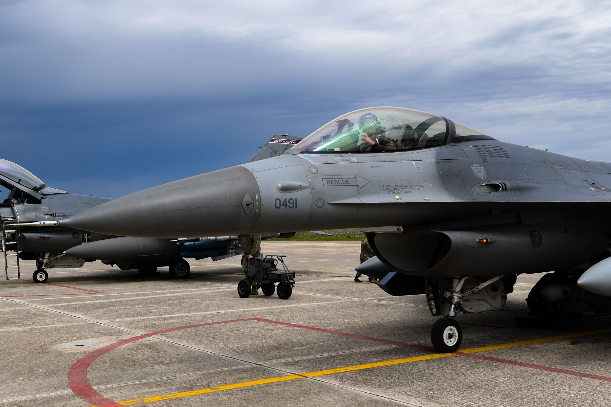 A U.S. Air Force pilot from the 510 Fighter Squadron (FS) poses with the ‘Buzzards’ hand signal at Andravida Air Base, Greece, April 13, 2021. The 510th FS operated out of Andravida while participating in INIOCHOS 21, an annual exercise designed to provide advanced and realistic aircrew training to strengthen interoperability of allied and partner air forces during joint operations and air defenses to maintain joint readiness. (U.S. Air Force photo by Airman 1st Class Thomas S. Keisler IV)