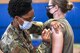 Staff Sgt. Tyler Watkins, 66th Medical Squadron noncommissioned officer in charge of immunizations, administers the COVID-19 vaccine to Maj. Erin Wilson, Tactical Data Network Enterprise deputy branch chief, at Hanscom Air Force Base, Mass., April 9. Hanscom expanded vaccine eligibility to include all base personnel in Tiers 1 and 2 as defined by the Department of Defense prioritization schema (U.S. Air Force photo by Mark Herlihy)