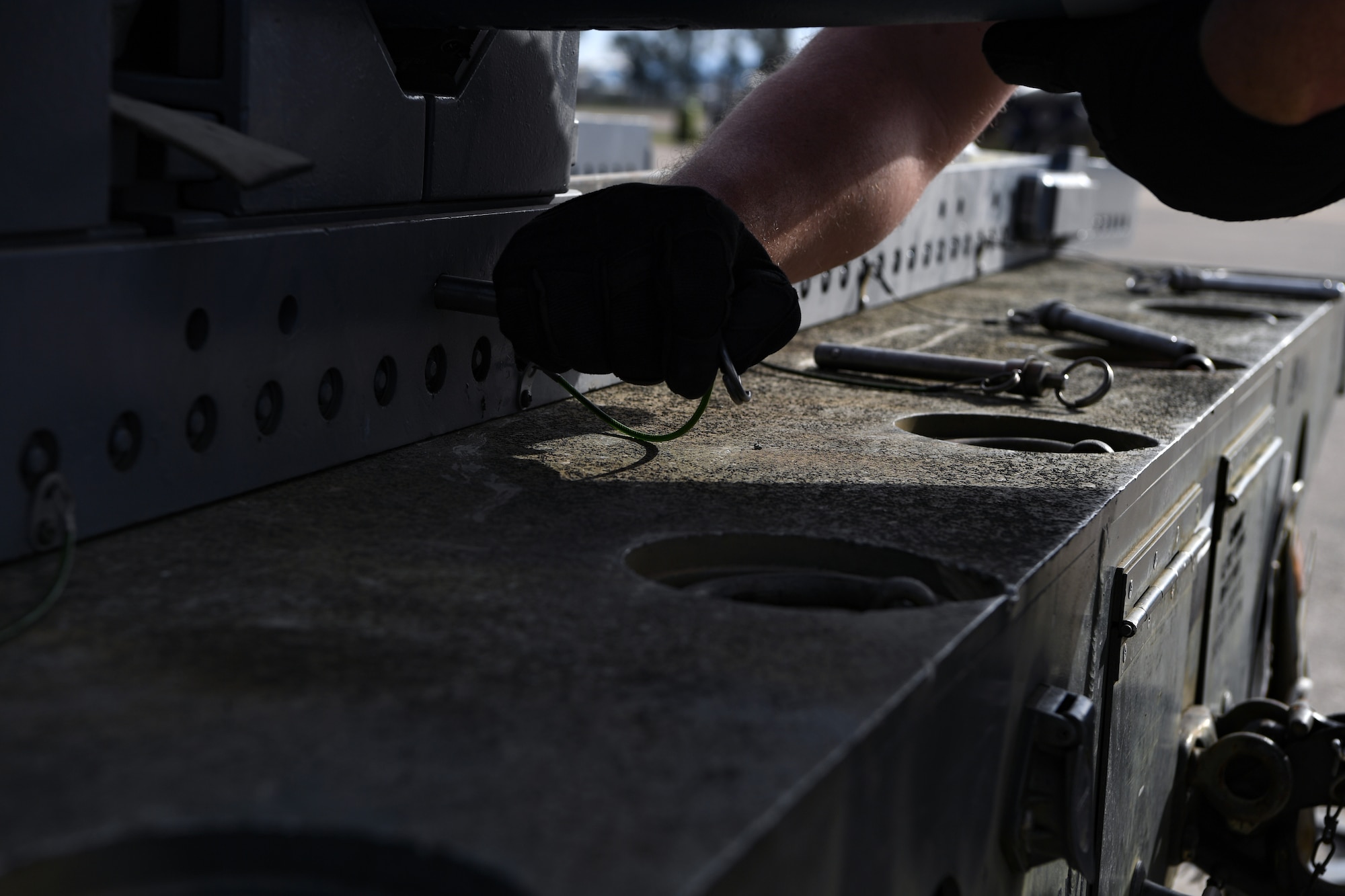A U.S. Airman with the 31st Munitions Squadron (MUNS) configures a trailer at Andravida Air Base, Greece, April 13, 2021. The 31st MUNS, along with other units from the 31st Fighter Wing, participated in INIOCHOS 21, a Hellenic air force-led, joint force exercise. (U.S. Air Force photo by Airman 1st Class Thomas S. Keisler IV)