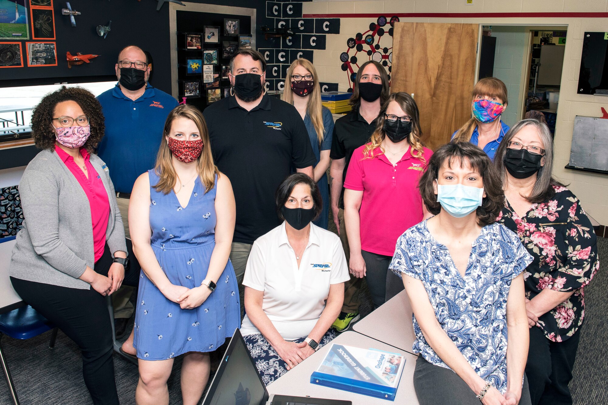 Martinsburg STARBASE and the Winchester STARBASE Academy staffs, photographed here in a Martinsburg STARBASE classroom April 8, 2021, collaborated recently to deliver their science, technology engineering and math lessons to students in Virginia and West Virginia. Typically students travel to the STARBASE locations, in Martinsburg, West Virginia, and Winchester, Virginia, but various COVID-19 pandemic policies in the schools created limitations on how the curriculum could be presented.
