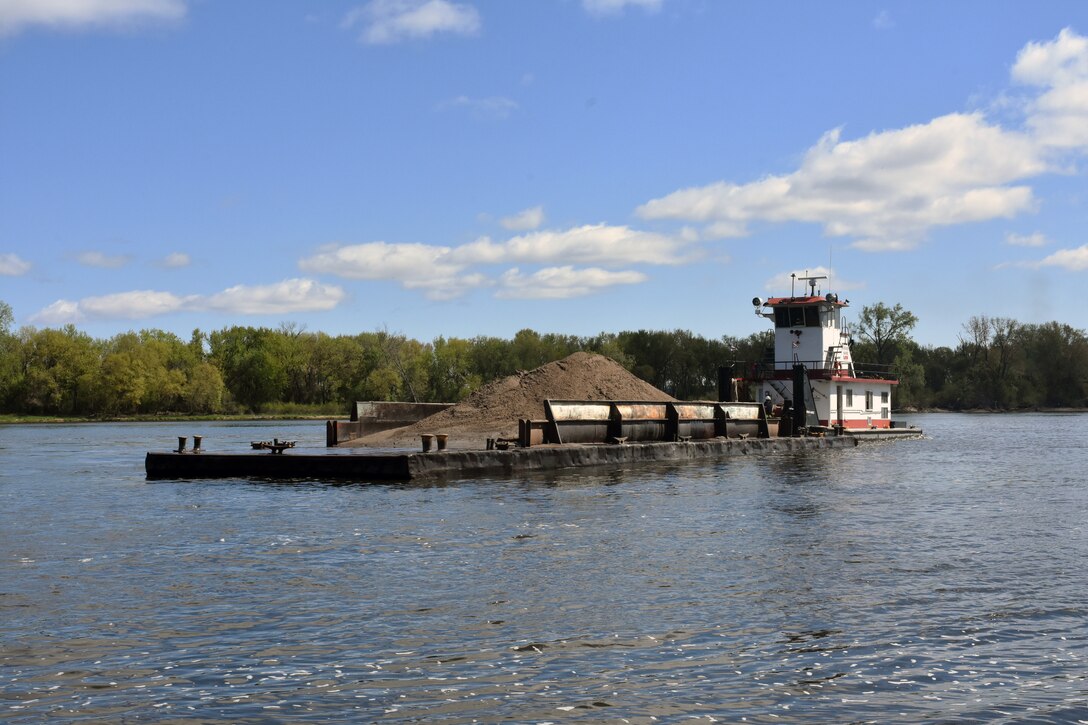 Barge moves dredged material