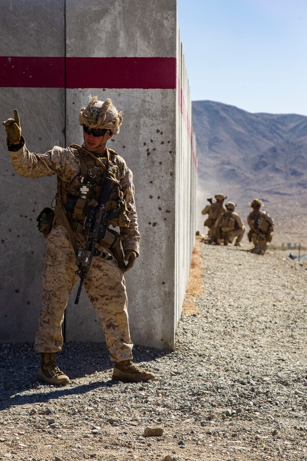 A U.S. Marine with 2nd Battalion, 8th Marines, 2nd Marine Division, gives orders during Live Fire Urban Attacks while participating in Integrated Training Exercise (ITX) 3-21 at Marine Corps Air Ground Combat Center, Twentynine Palms, California, April 13, 2021. The purpose of ITX is to create a challenging, realistic training environment that produces combat-ready forces capable of operating as an integrated Marine Air Ground Task Force. (U.S. Marine Corps photo by Lance Cpl. Nathan Maysonet)