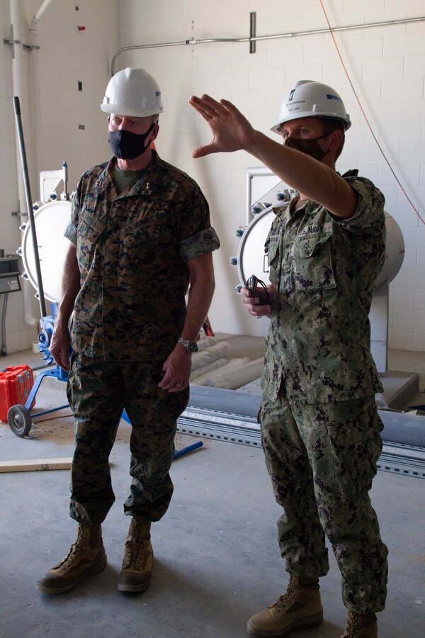 U.S. Marine Corps Maj. Gen. Edward Banta, commander, Marine Corps Installations Command (MCICOM), tours the potable water treatment plant at Marine Corps Air Ground Combat Center, Twentynine Palms, California, April 13, 2021. Lieutenant Junior Grade Trevor Hildebrand, construction manager, explains the reverse osmosis system and its support to the resilience of the Combat Center. (U.S. Marine Corps photo by Lance Cpl. Jacquilyn Davis)