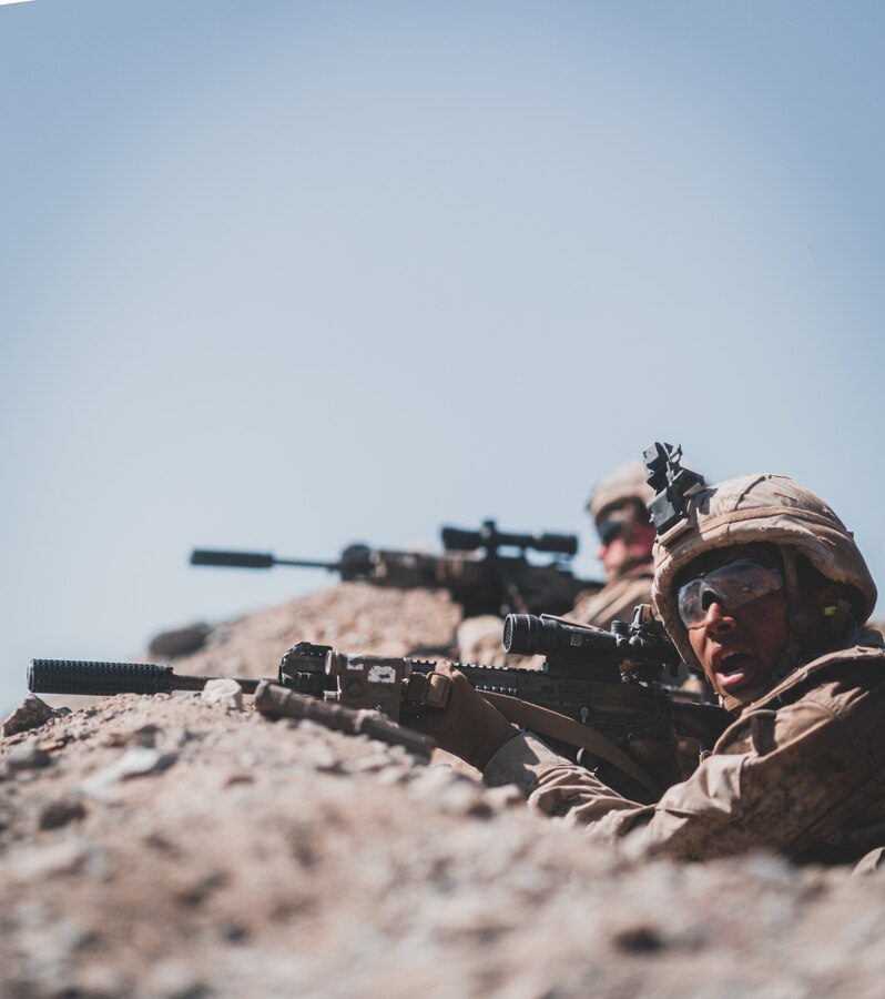 A U.S. Marine with Bravo Company, 1st Battalion, 5th Marine Regiment, 1st Marine Division, calls for an ammo, casualties, equipment count during supported company attacks at Range 400 while participating in Integrated Training Exercise 3-21 at Marine Corps Air Ground Combat Center, Twentynine Palms, California, April 12, 2021. The purpose of ITX is to create a challenging, realistic training environment that produces combat-ready forces capable of operating as an integrated Marine Air Ground Task Force. (U.S. Marine Corps photo by Lance Cpl. Colton Brownlee)