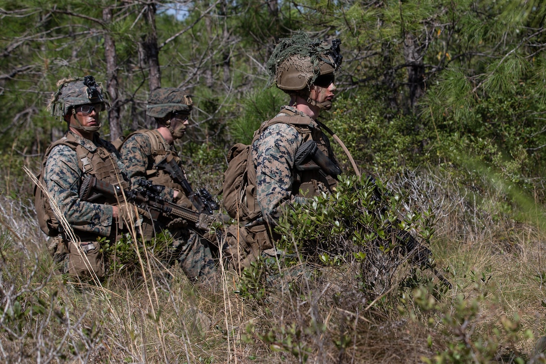 U.S. Marine Corps Lance Cpl. William McKenzie, a native of Florence, S.C., and a rifleman with Alpha Company, 1st Battalion, 6th Marine Regiment (1/6), 2d Marine Division, awaits commands during a squad fire and maneuver training event on Camp Lejeune, N.C., April 13, 2021. Marines with 1/6 conducted the exercise to maintain proficiency in squad combat maneuvers and the ability to operate in adverse environments. This training is the next step on the road to becoming an apex battalion task force. (U.S. Marine Corps photo by Lance Cpl. Jennifer E. Reyes)