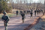 Soldiers of the 235th Military Police Detention Company, South Dakota Army National Guard, conduct a tactical road march April 10, 2021, at West Camp Rapid in Rapid City, S.D. The 235th rehearsed mission-essential tasks during a field training exercise to prepare for its state and federal missions.