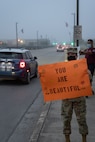 U.S. Air Force Capt. Brandy Dorrough, assistant director of the 323rd Training Squadron, greets cars during the We Care Day event, April 16th, 2021, at Joint Base San Antonio-Lackland, Texas.