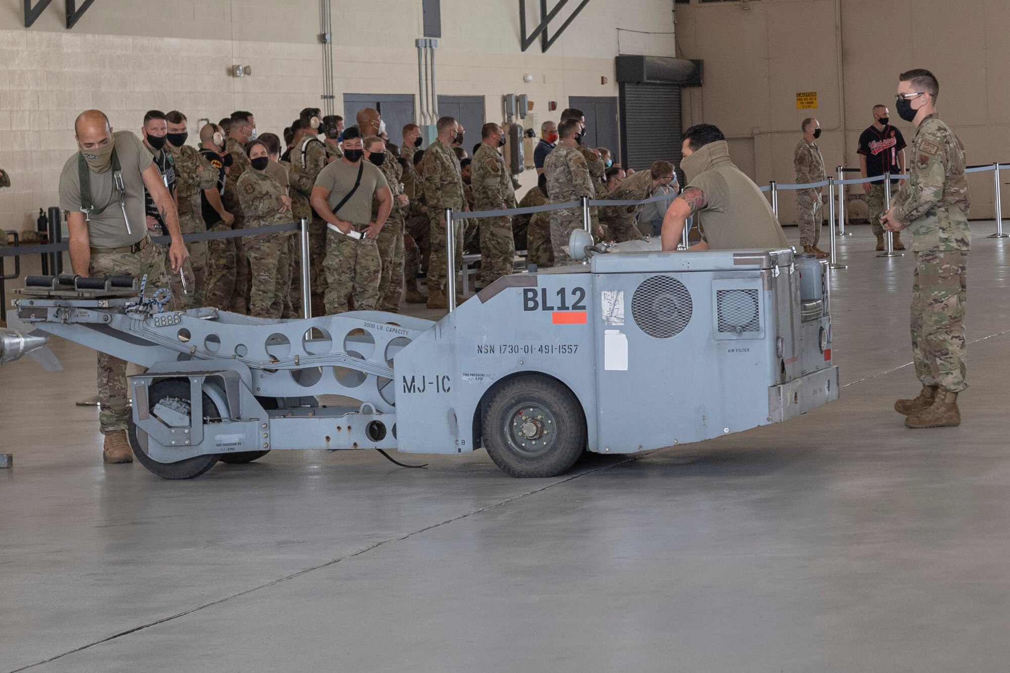 Photo of Airmen preparing to lift a munition