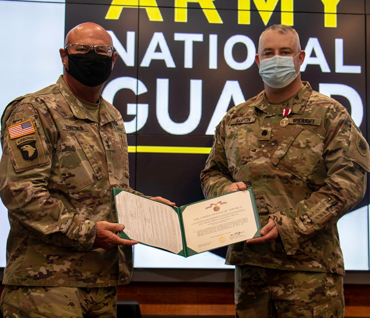 Newly promoted Lt. Col. Michael Barton, of Greenview, Illinois, (right) receives the Meritorious Service Medal from Maj. Gen. Michael R. Zerbonia, Assistant Adjutant General – Army, Illinois National Guard and Commander, Illinois Army National Guard, for Barton’s work as the Assistant to the Chief of Staff, Illinois Army National Guard.