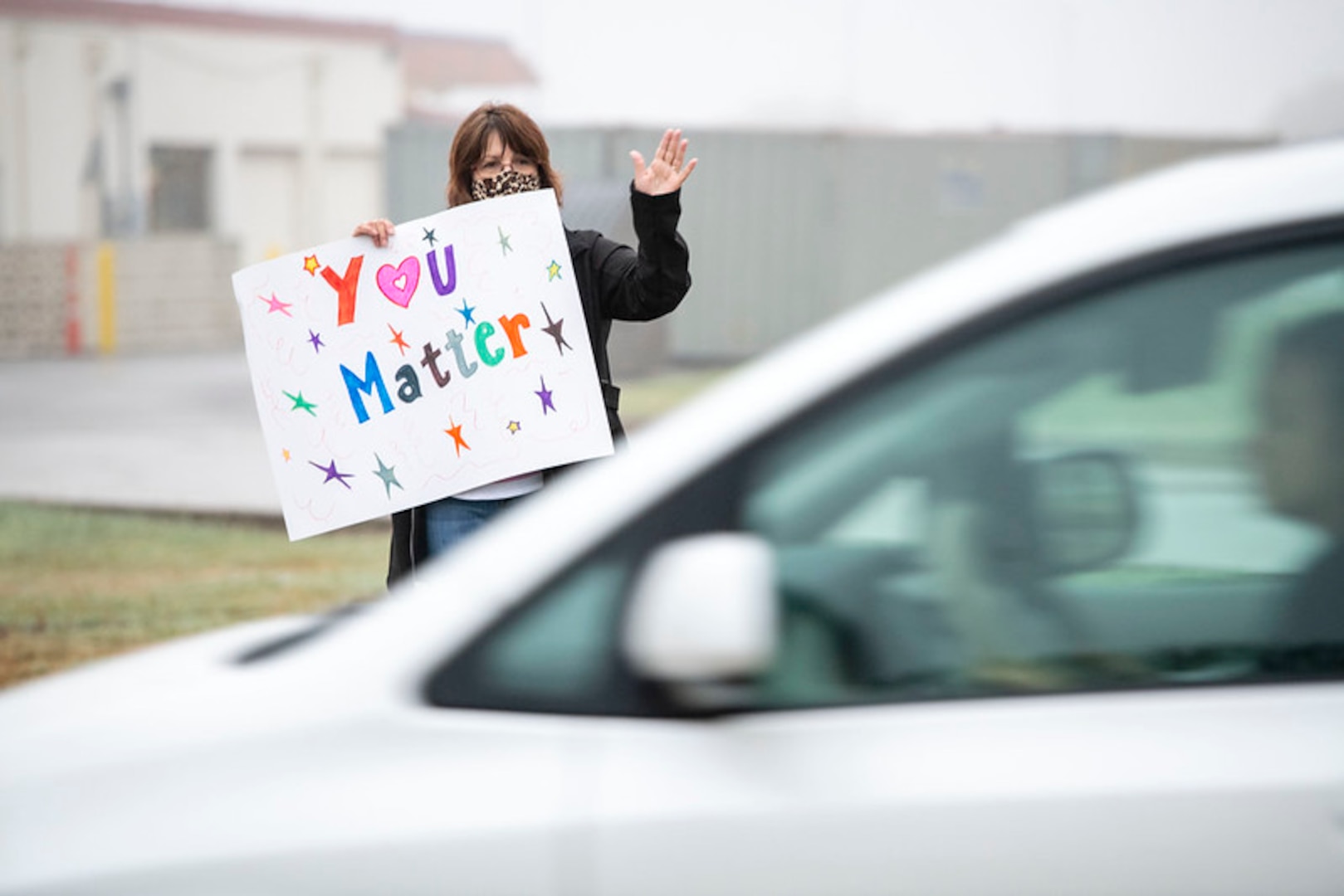 Volunteers hold signs in support of the We Care Day event April. 16, 2021, at Joint Base San Antonio-Randolph, Texas. The event was in support of Month of the Military Child and Child Abuse awareness month.