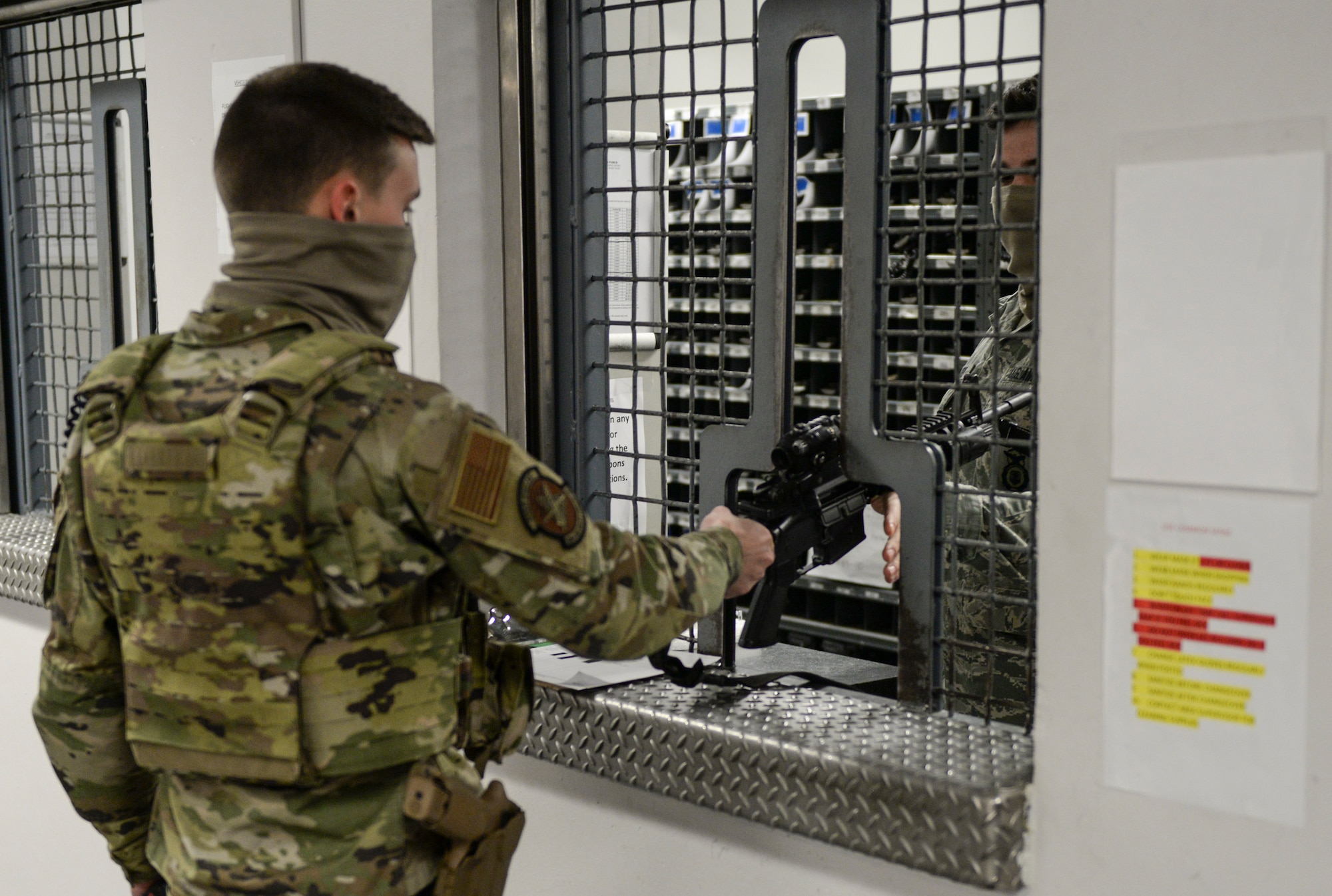 U.S. Air Force Airman 1st Class Matthew Martz, 88th Security Forces Squadron patrolman, receives his M-4 Carbine rifle from the armory prior to going to his post, March 16, 2021 at Wright-Patterson Air Force Base, Ohio. Security Forces members are responsible for providing base defense, as well as providing law enforcement on the installation. (U.S. Air Force photo by Wesley Farnsworth)