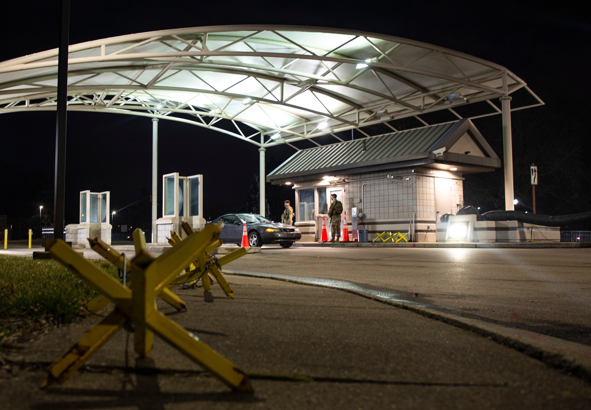 88th Security Forces Squadron patrolmen U.S. Air Force Staff Sgt. Donald Wagner and Airman 1st Class Ian Hunt check identification cards of people attempting to gain access to the base through gate 12A, March 16, 2021 at Wright-Patterson Air Force Base, Ohio. Security Forces members are responsible for providing base defense, as well as providing law enforcement on the installation. (U.S. Air Force photo by Wesley Farnsworth)