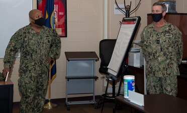 Newport, R.I. (April 13, 2021) Command Master Chief Baron Randle, director, Senior Enlisted Academy (SEA), left, gives Rear Adm. Pete Garvin, commander, Naval Education and Training Command, a tour of the SEA during a visit to Naval Station (NAVSTA) Newport R.I., April 13. While onboard NAVSTA Newport, Garvin also visited Navy Supply Corps School, Center for Service Support, Naval Chaplaincy School and Center, and Surface Warfare Schools Command. (U.S. Navy photo by Mass Communication Specialist 2nd Class Derien C. Luce)