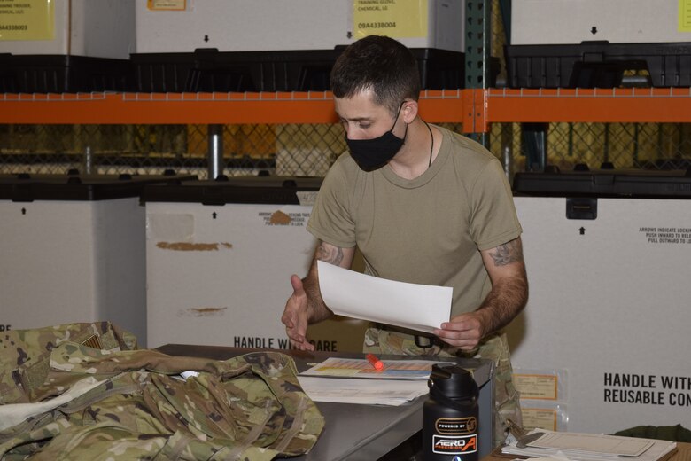 Staff Sgt. Taylor Mogford, 433rd Logistics Readiness Squadron individual protective equipment supervisor, goes through a checklist to ensure all equipment is accounted for at Joint Base San Antonio-Lackland, Texas, April 7, 2021. Mogford has been with the 433rd LRS almost five years and in 2020 assembled a team to revamp logistics training in the Air Force. (U.S. Air Force photo by Senior Airman Brittany Wich)