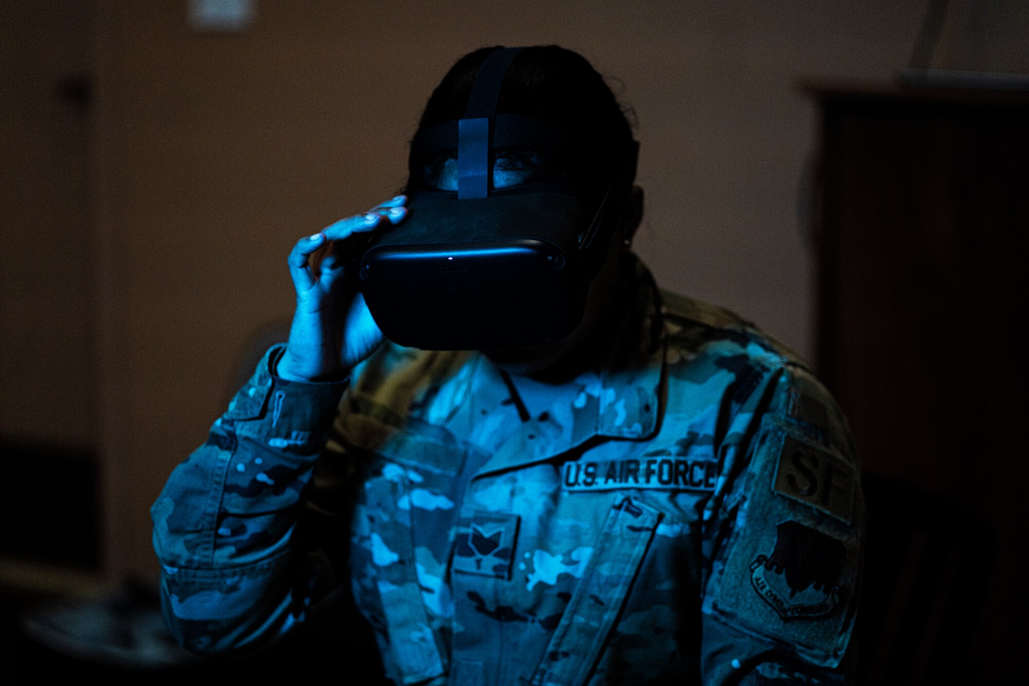 A 432nd Security Forces Squadron wears virtual reality goggles in the dark