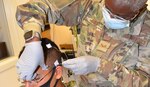 Air Force Senior Airman Jamila Basit, a student in the Neurodiagnostic Technician program at the Medical Education and Training Campus, practices the electrode application method required for performance of the Electroencephalogram (EEG) on fellow student, Navy Seaman Marcus Falcon.