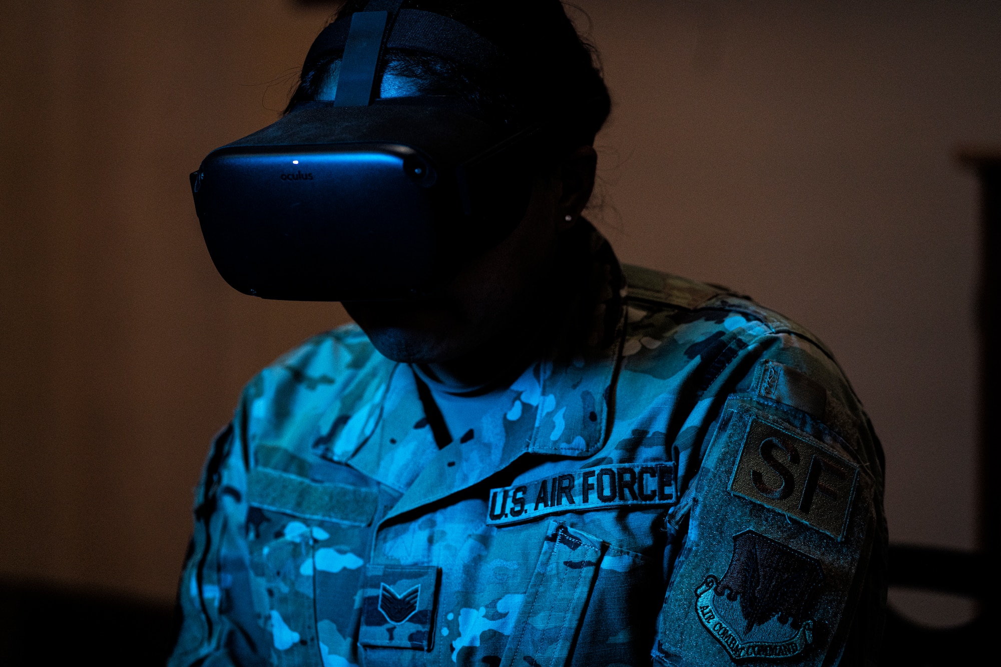 A 432nd Security Forces Squadron wears virtual reality goggles in the dark