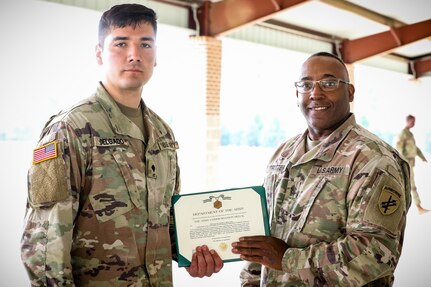 U.S. Army Reserve Spc. Jaime Delgado, left, a civil affairs specialist with the 352nd Civil Affairs Command, is awarded an army commendation medal from Command Sgt. Maj, Petter Trotter, the senior enlisted leader of United States Army Civil Affairs and Psychological Operations Command (Airborne), for being named Soldier of the Year during the 2021 U.S. Army Civil Affairs and Psychological Operations Command (Airborne) Best Warrior Competition at Fort Jackson, S.C., April 10, 2021. The USACAPOC(A) BWC is an annual competition that brings in competitors from across USACAPOC(A) to earn the title of “Best Warrior.” BWC tests the Soldiers’ individual ability to adapt and overcome challenging scenarios and battle-focused events, testing their technical and tactical skills under stress and extreme fatigue.