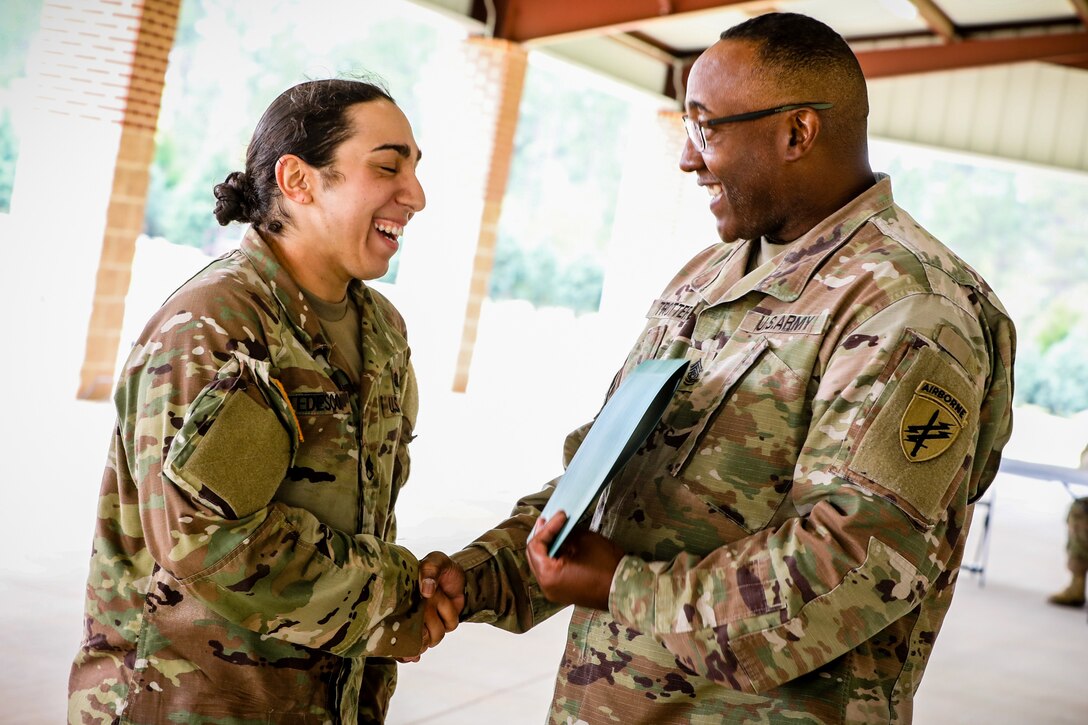 Staff Sgt. Natalie Tedesco, left, a psychological operations specialist with the 303rd Psychological Operations Company, receives an award from Command Sgt. Maj, Petter Trotter, the senior enlisted advisor of U.S. Army Civil Affairs and Psychological Operations Command (Airborne), for competing during the 2021 U.S. Army Civil Affairs and Psychological Operations Command (Airborne) Best Warrior Competition at Fort Jackson, S.C., April 10, 2021. The USACAPOC(A) BWC is an annual competition that brings in competitors from across USACAPOC(A) to earn the title of “Best Warrior.” BWC tests the Soldiers’ individual ability to adapt and overcome challenging scenarios and battle-focused events, testing their technical and tactical skills under stress and extreme fatigue.