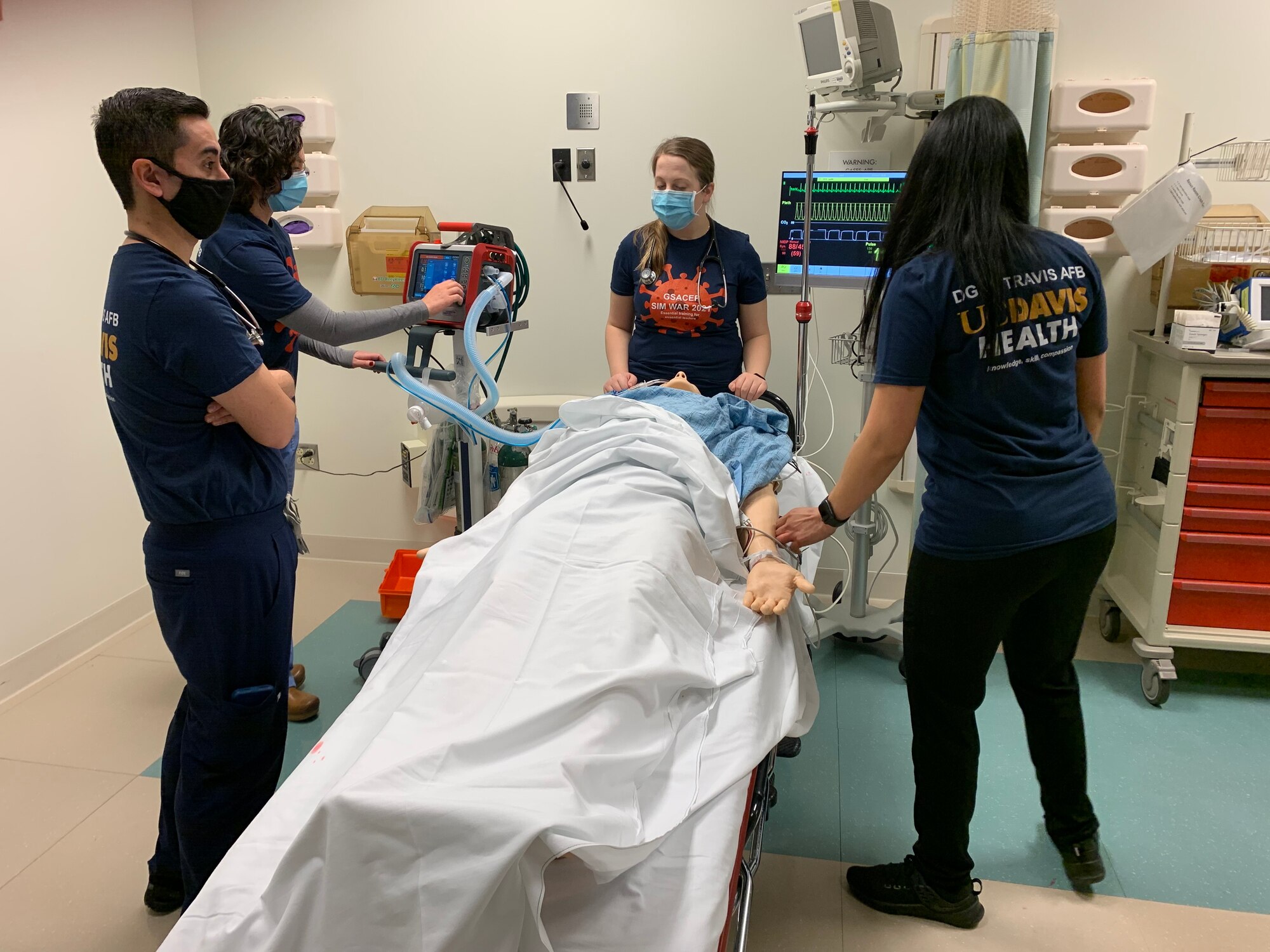 Members of the U.S. Air Force UC Davis Health residency team perform lifesaving procedures on a Laerdal Sim Man 3G Mannequin during the Government Service Chapter of the American College of Emergency Physicians SimWars April 8, 2021, at Travis Air Force Base, California. SimWars is an event where teams from the Air Force, Army and Navy compete in three rounds with five different real-life, austere situations and are rated on how well they respond to the emergencies. This year the event was virtual. (Courtesy photo)