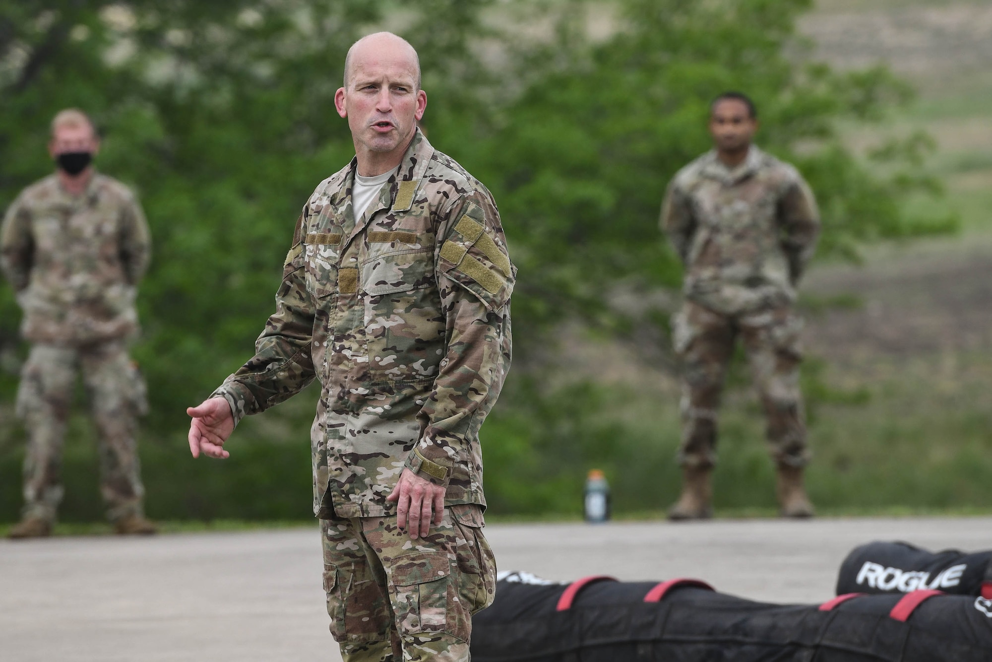 JOINT BASE SAN ANTONIO-CHAPMAN TRAINING ANNEX, Texas—Chief Master Sgt. Todd M. Popovic, Special Warfare Training Wing, or SWTW, command chief, leads a formation in memorial pushups after a memorial log carry for fallen airman, Lt. Col. William Schroeder, at the SWTW located on Joint Base San Antonio-Chapman Training Annex, or JBSA-CTA, Apr. 8, 2021.