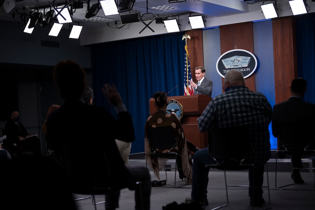 A man briefs the media inside the Pentagon.