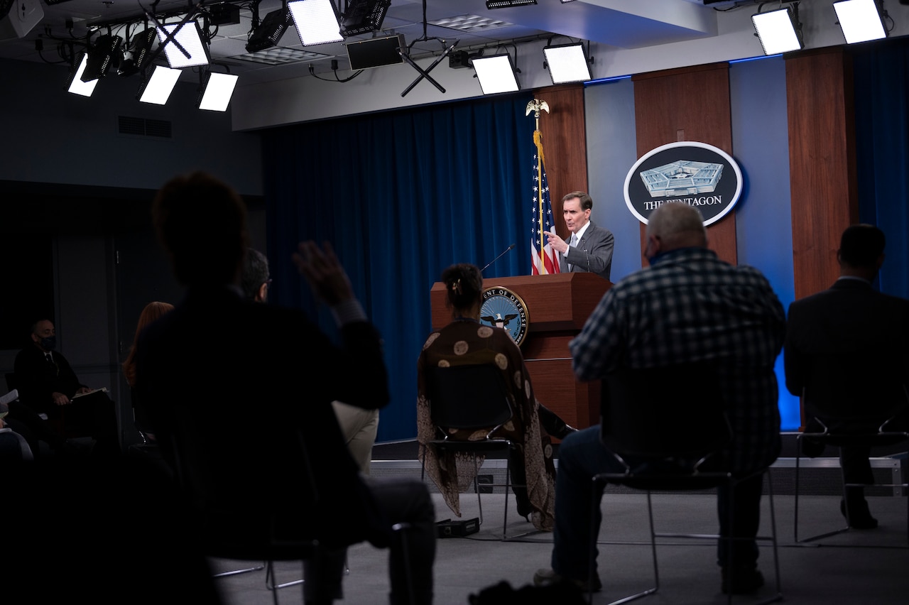 A man briefs the media inside the Pentagon.
