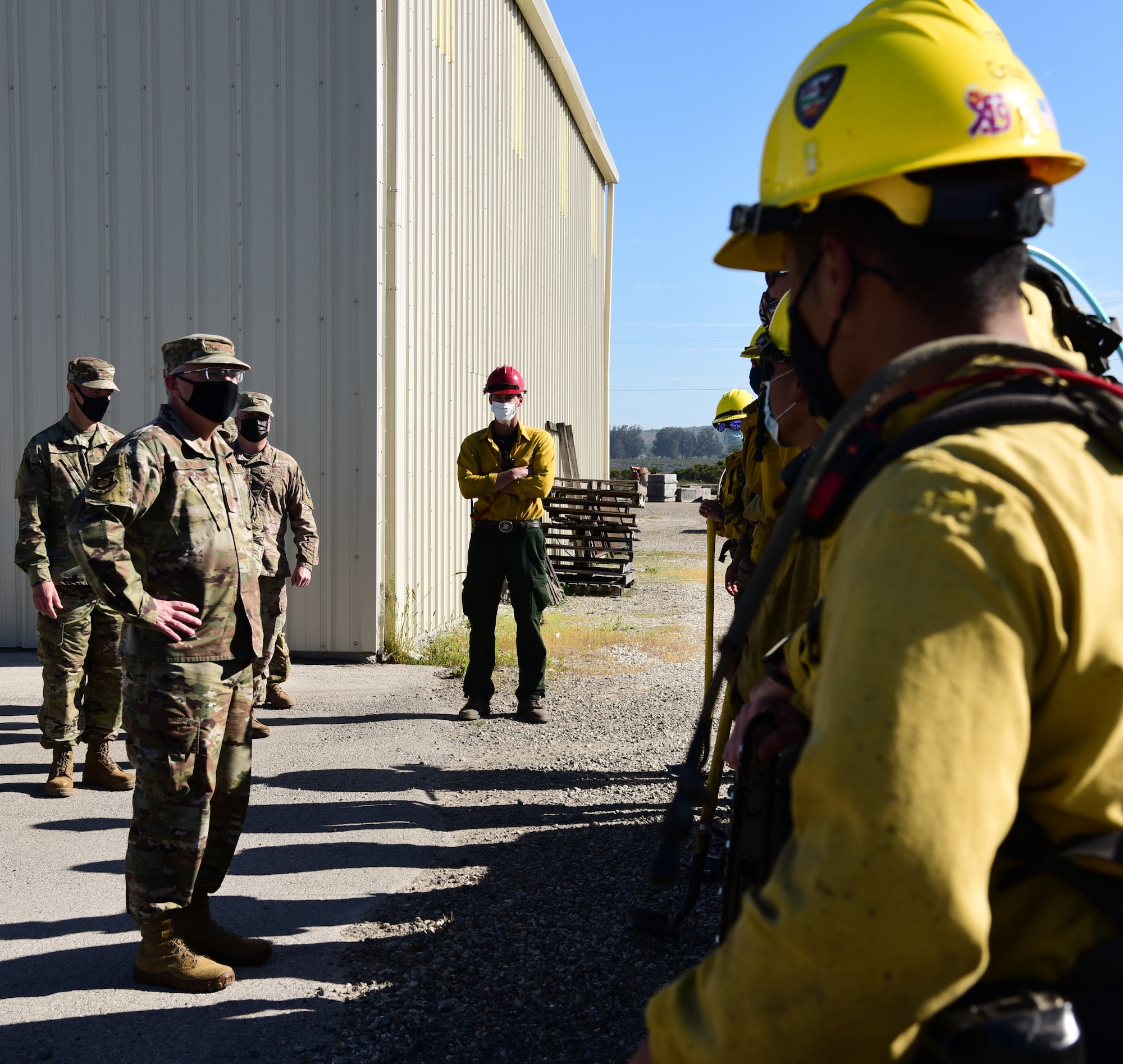The 30th Space Wing Hotshot firefighters explain how the team extinguishes brush fires to Lt. Gen. John F. Thompson, U.S. Space Force’s Space and Missile Systems Center commander, April 9, 2021, at Vandenberg Air Force Base, Calif. Due to Vandenberg AFB’s location, wildland fires are a common occurrence during the summer months and the Hotshots play a major role in keeping the installation ready and able to continue the mission. (U.S. Space Force photo by Airman 1st Class Rocio Romo)