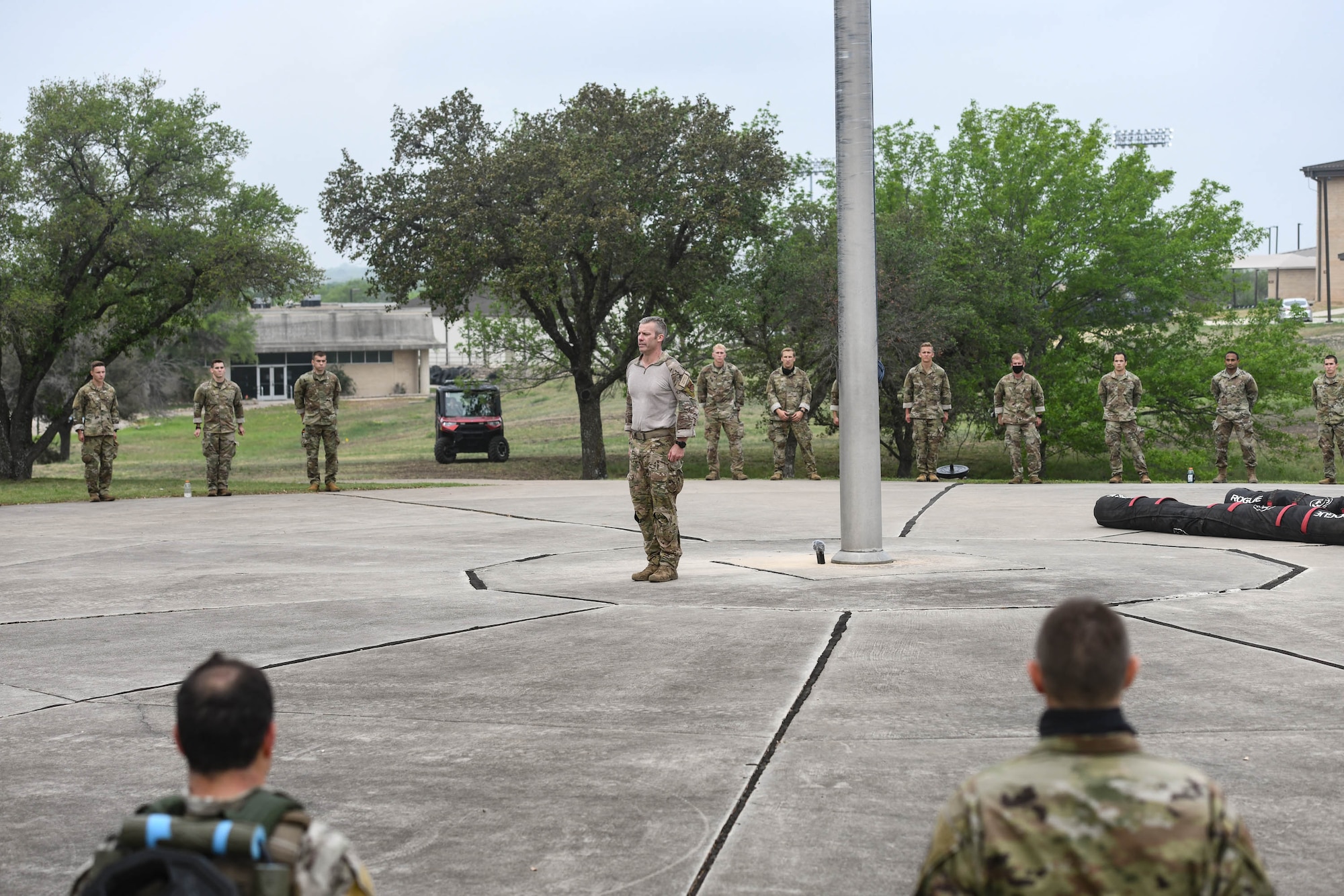 JOINT BASE SAN ANTONIO-CHAPMAN TRAINING ANNEX, Texas—Chief Master Sgt. Todd M. Popovic, Special Warfare Training Wing, or SWTW, command chief, leads a formation in memorial pushups after a memorial log carry for fallen airman, Lt. Col. William Schroeder, at the SWTW located on Joint Base San Antonio-Chapman Training Annex, or JBSA-CTA, Apr. 8, 2021.