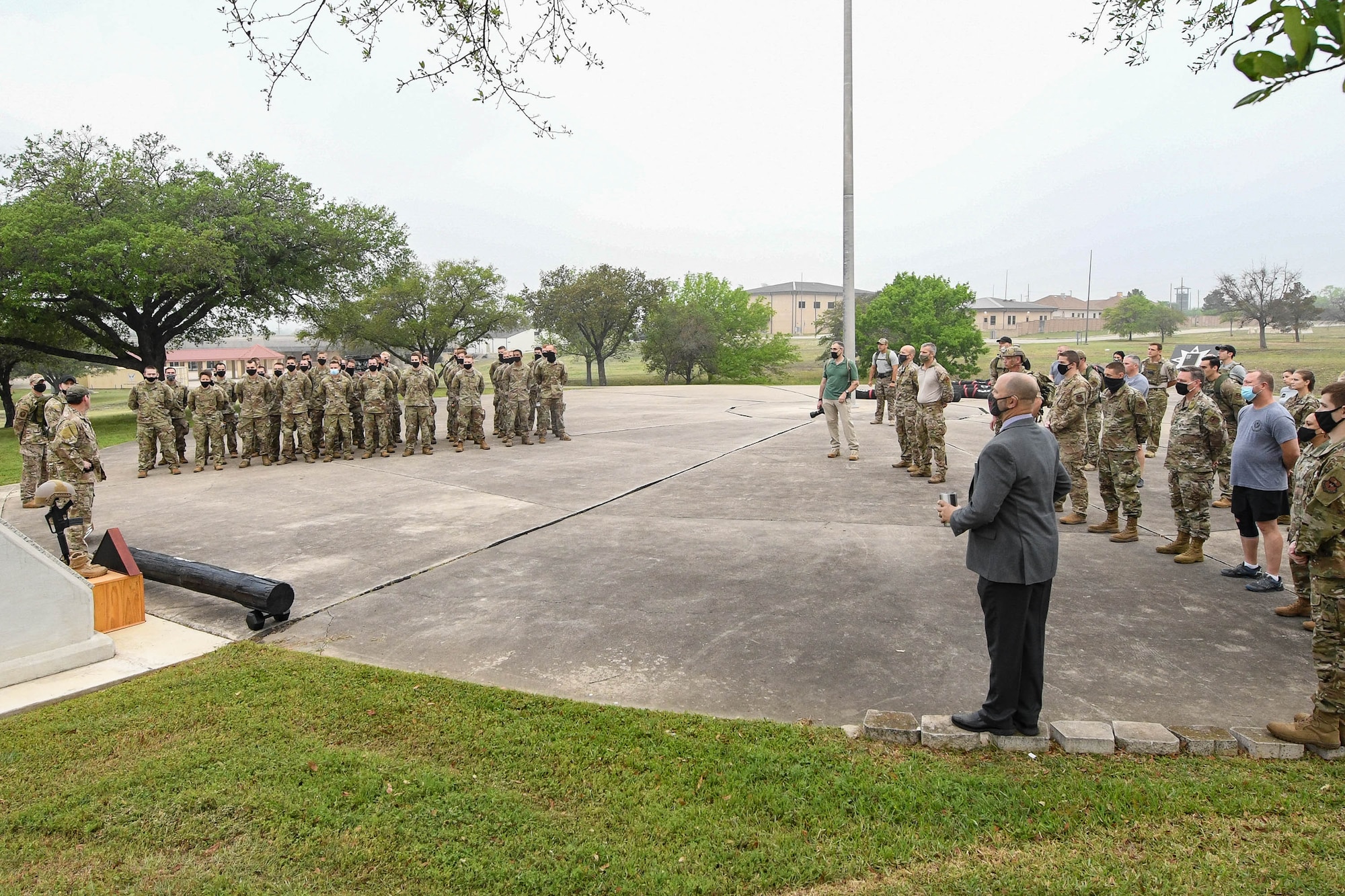 JOINT BASE SAN ANTONIO-CHAPMAN TRAINING ANNEX, Texas—Chief Master Sgt. Todd M. Popovic, Special Warfare Training Wing, or SWTW, command chief, leads a formation in memorial pushups after a memorial log carry for fallen airman, Lt. Col. William Schroeder, at the SWTW located on Joint Base San Antonio-Chapman Training Annex, or JBSA-CTA, Apr. 8, 2021.