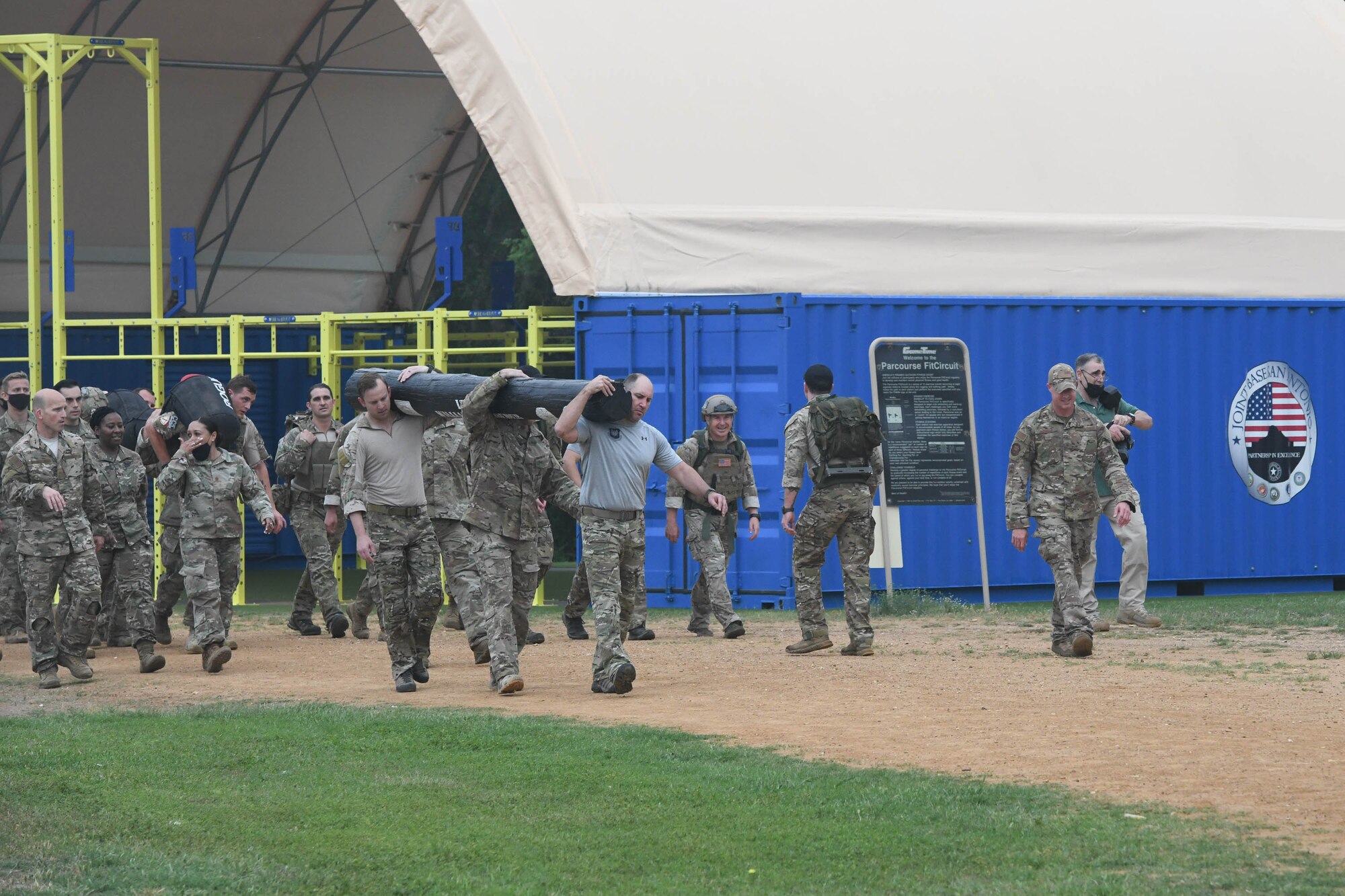 JOINT BASE SAN ANTONIO-CHAPMAN TRAINING ANNEX, Texas—Chief Master Sgt. Todd M. Popovic, Special Warfare Training Wing, or SWTW, command chief, leads a formation in memorial pushups after a memorial log carry for fallen airman, Lt. Col. William Schroeder, at the SWTW located on Joint Base San Antonio-Chapman Training Annex, or JBSA-CTA, Apr. 8, 2021.