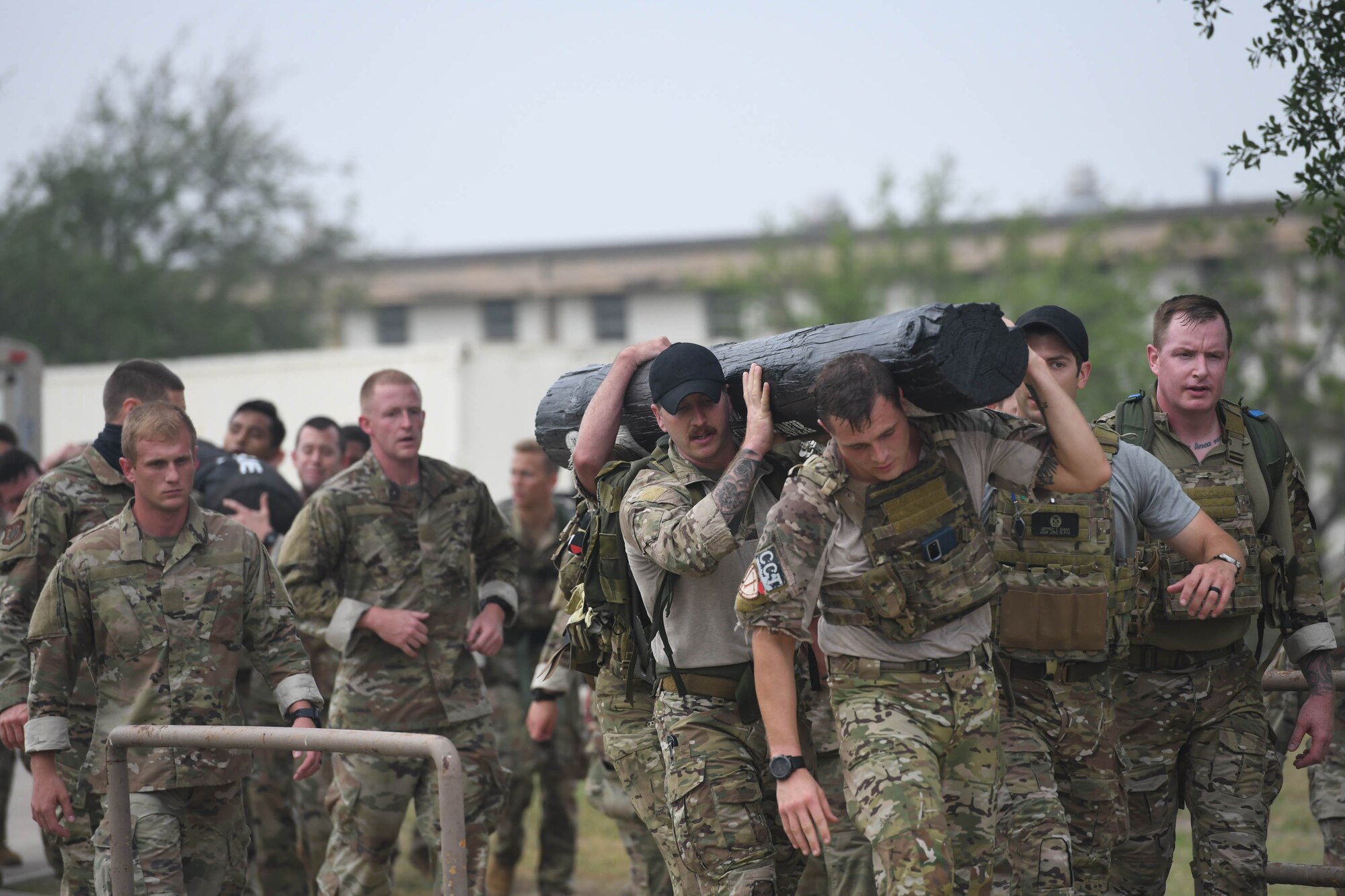 JOINT BASE SAN ANTONIO-CHAPMAN TRAINING ANNEX, Texas—Chief Master Sgt. Todd M. Popovic, Special Warfare Training Wing, or SWTW, command chief, leads a formation in memorial pushups after a memorial log carry for fallen airman, Lt. Col. William Schroeder, at the SWTW located on Joint Base San Antonio-Chapman Training Annex, or JBSA-CTA, Apr. 8, 2021.