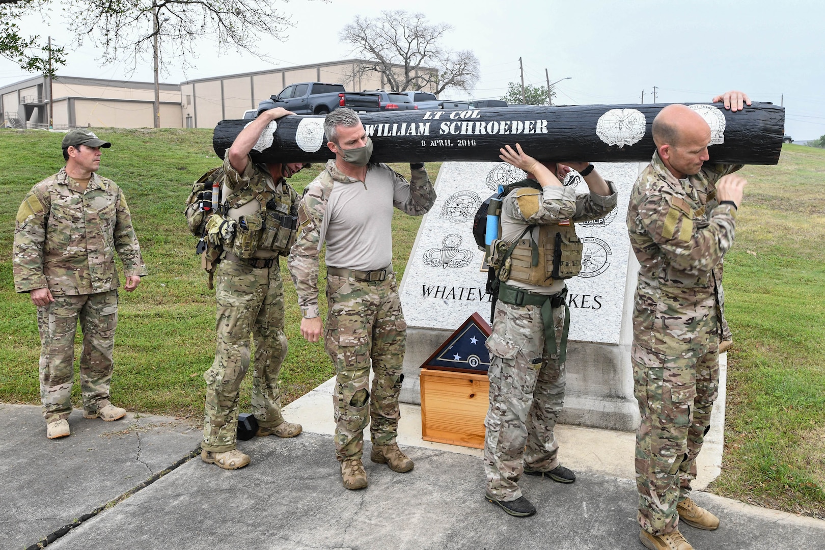 JOINT BASE SAN ANTONIO-CHAPMAN TRAINING ANNEX, Texas—Chief Master Sgt. Todd M. Popovic, Special Warfare Training Wing, or SWTW, command chief, leads a formation in memorial pushups after a memorial log carry for fallen airman, Lt. Col. William Schroeder, at the SWTW located on Joint Base San Antonio-Chapman Training Annex, or JBSA-CTA, Apr. 8, 2021.