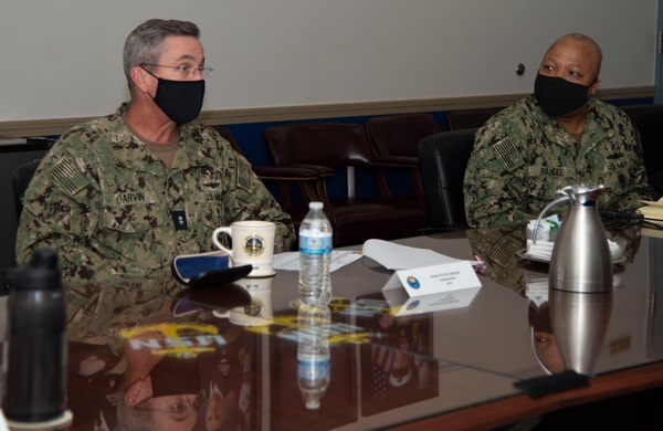 Newport, R.I. (April 13, 2021) Rear Adm. Pete Garvin, commander, Naval Education and Training Command, left, reviews a presentation with Command Master Chief Baron Randle, director, Senior Enlisted Academy, during a visit to Naval Station (NAVSTA) Newport R.I., April 13. While onboard NAVSTA Newport, Garvin also visited Navy Supply Corps School, Center for Service Support, Naval Chaplaincy School and Center, and Surface Warfare Schools Command. (U.S. Navy photo by Mass Communication Specialist 2nd Class Derien C. Luce)