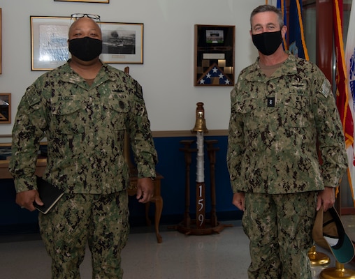 Newport, R.I. (April 13, 2021) Rear Adm. Pete Garvin, commander, Naval Education and Training Command, right, poses with Command Master Chief Baron Randle, director, Senior Enlisted Academy, during a visit to Naval Station (NAVSTA) Newport R.I., April 13. While onboard NAVSTA Newport, Garvin also visited Navy Supply Corps School, Center for Service Support, Naval Chaplaincy School and Center, and Surface Warfare Schools Command. (U.S. Navy photo by Mass Communication Specialist 2nd Class Derien C. Luce)