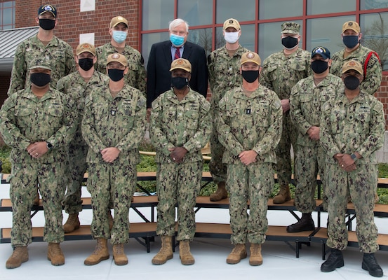 Newport, R.I. (April 13, 2021) Rear Adm. Pete Garvin, commander, Naval Education and Training Command poses for a photo with NETC-domain command leadership in front of Naval Supply Corps School onboard Naval Station (NAVSTA) Newport April 13. While onboard NAVSTA Newport, Garvin also visited Center for Service Support, Naval Chaplaincy School and Center, Surface Warfare Schools Command, and the Senior Enlisted Academy.  (U.S. Navy photo by Mass Communication Specialist 2nd Class Derien C. Luce)