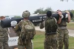 JOINT BASE SAN ANTONIO-CHAPMAN TRAINING ANNEX, Texas—350 Special Warfare Training Squadron, or SWTS, organized a two and a half-mile memorial log carry for fallen airman, Lt. Col. William Schroeder at the Special Warfare Training Wing, or SWTW,  located on Joint Base San Antonio-Chapman Training Annex, or JBSA-CTA, Apr. 8, 2021. 

A memorial log created for Schroeder along with three 600-pound each workout worms, were carried on a path that navigated through past areas of the former 342 Training Squadron Schroeder commanded. Service members swapped places to carry the log and then assembled around the SWTW flagpole and the Circle of Honor to perform a  memorial push-up ceremony. A tradition amongst the special warfare community to honor fallen members.

On April 8, 2016, Maj. William “Bill” Schroeder, 342 Training Squadron, commander, who was a special operations weather officer, was killed on JBSA-Medina Annex in what became a murder-suicide. An Airman facing a disciplinary hearing arrived at the office and began shooting. Schroeder’s reaction is credited with saving the life of his First Sergeant, and potentially many others. (U.S. Air Force digital photo by Andrew C. Patterson)