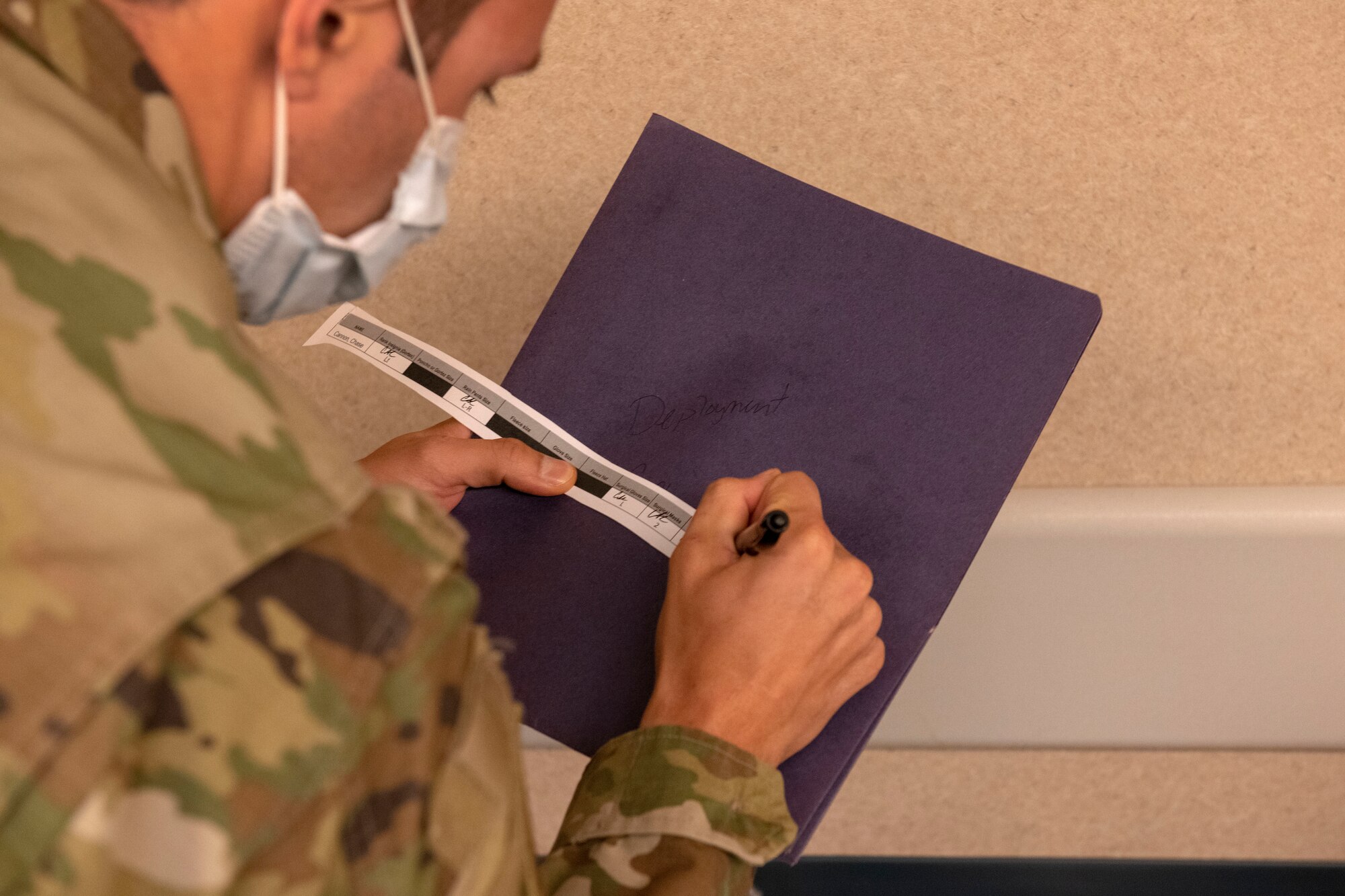 An Airman completes a deployment checklist