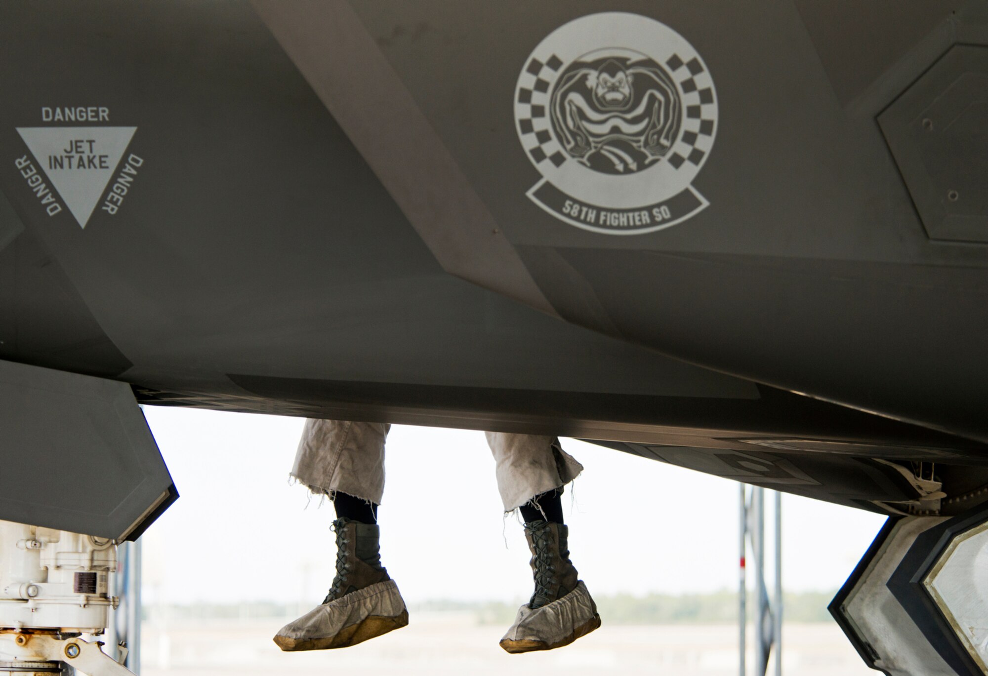 A 58th Fighter Squadron maintainer climbs out of the intake of an F-35A Lightning II after performing post-flight checks on the aircraft. The 58th FS is part of the 33rd Fighter Wing, a joint graduate flying and maintenance training wing for the F-35. (U.S. Air Force photo/Tech. Sgt. Bennie J. Davis III)