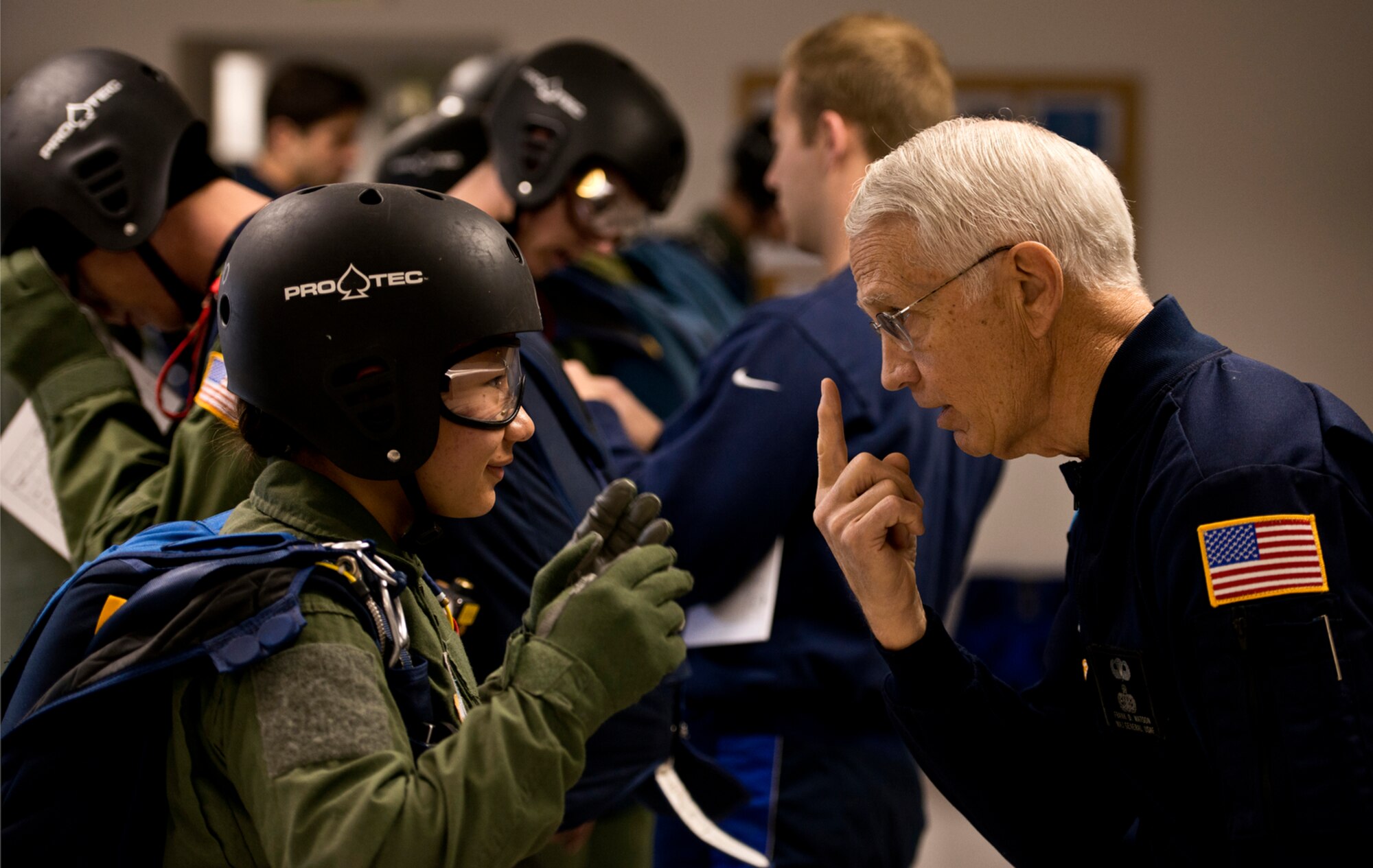 Retired Major Gen. Frank Watson provides a pep talk to Cadet 1st Class Crystal Johnson as she prepares for her first free-fall parachute jump. Gen. Watson also jumped in the AM490 program at the age of 50 and now comes to the academy to help motivate cadets before their initial jump. (U.S. Air Force photo/Tech. Sgt. Bennie J. Davis III)