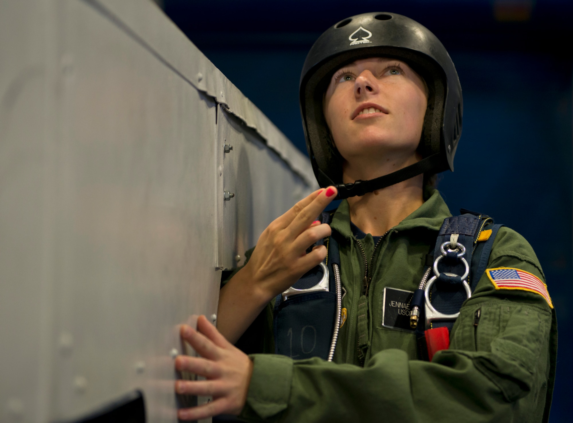U.S. Air Force Academy Cadet Jennae Stienmiller of the U.S. Coast Guard, receives the "go" signal from her jump master as she stands in the door of a mock aircraft preparing to simulate a parachute free-fall jump. (U.S. Air Force photo/Tech. Sgt. Bennie J. Davis III)