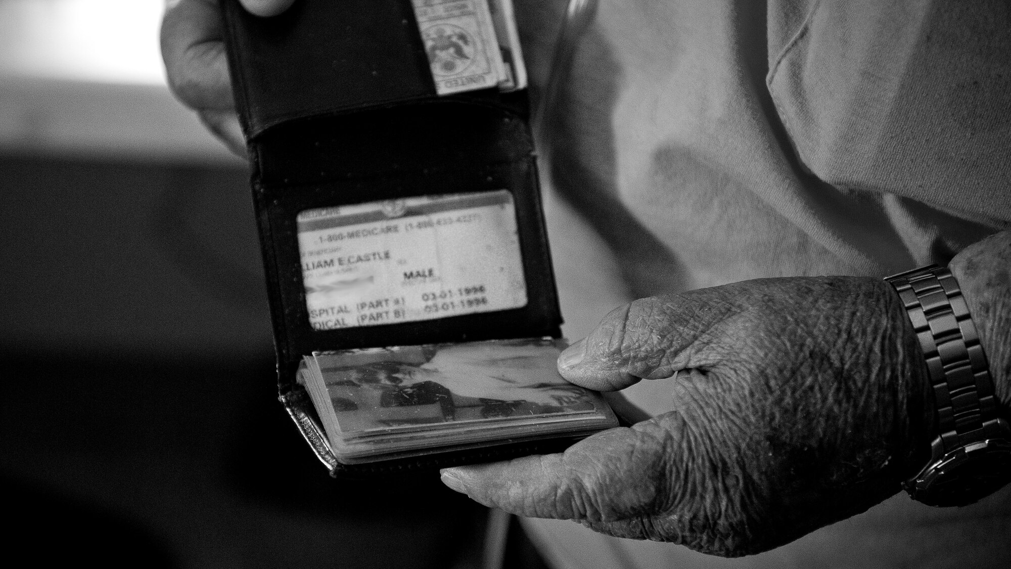 Seventeen years after losing his wife, Mary, to ovarian cancer, Bill Castle still carries a photo of her in his wallet. (Parts of this image have masked to protect personal information) (U.S. Air Force photo/Staff Sgt. Andrew Lee)