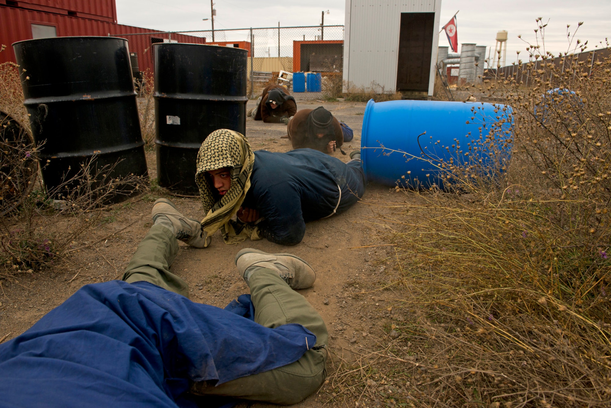 U.S. Air Force survival, evasion, resistance and escape students low crawl through a simulated training environment wearing improvised clothing to teach them to escape capture during SERE training at Fairchild Air Force Base, Wash. (U.S. Air Force photo/Tech. Sgt. Bennie J. Davis III)