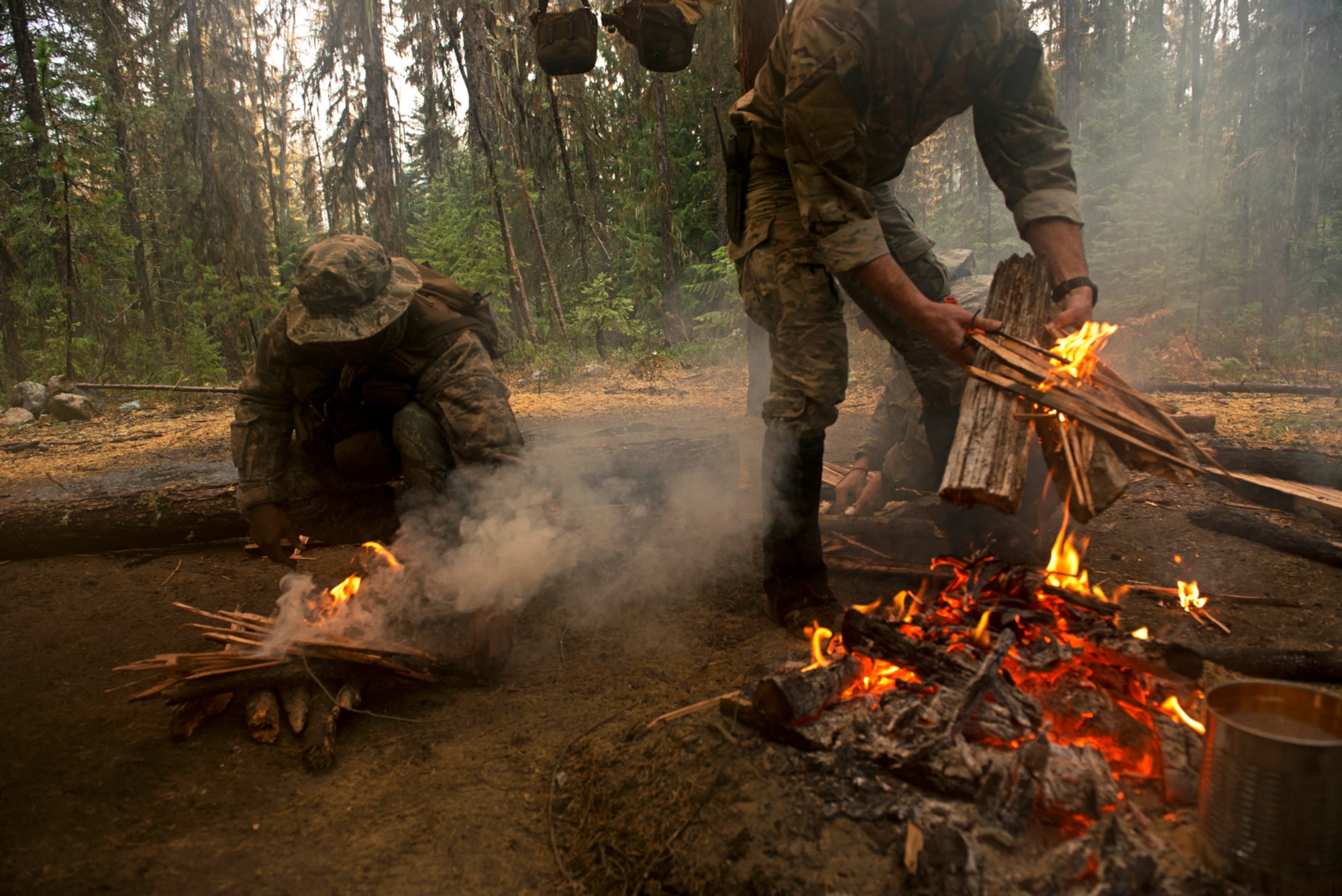 Survival, evasion, resistance and escape students build fires while learning to create improvised shelters in the mountains of the Colville National Forest SERE training site. Students will be taught the means to survive and then will be released into the woods to evade capture and use their newly learned skills. (U.S. Air Force photo/Tech. Sgt. Bennie J. Davis III)
