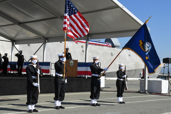 Navy Operational Support Center (NOSC) Alameda Sailors present the colors during the USS Oakland (LCS 24) commissioning ceremony.